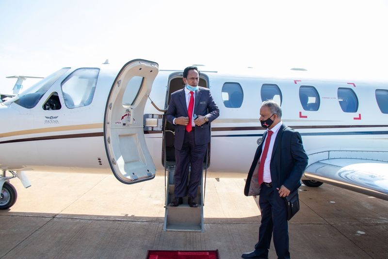 The Chairman stepping off a private jet on arrival in South Sudan